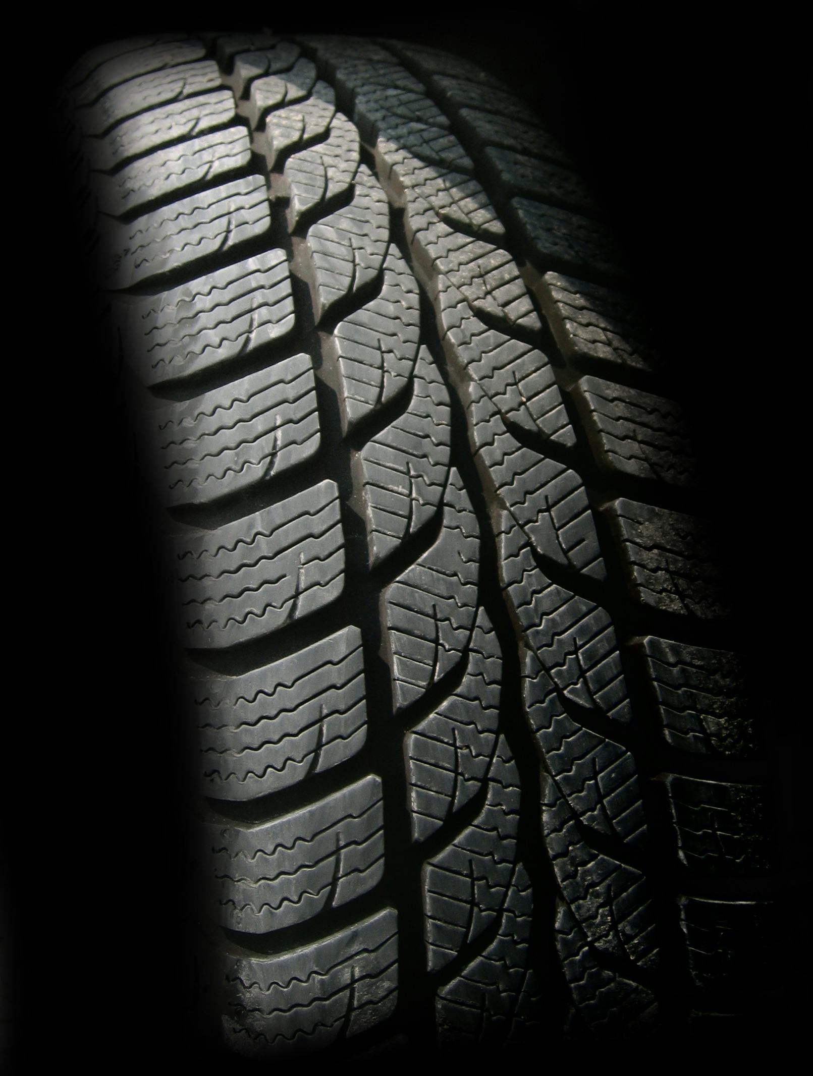 Detailed close-up image of a rubber tire showcasing texture and tread pattern, ideal for design concepts.