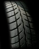 Detailed close-up image of a rubber tire showcasing texture and tread pattern, ideal for design concepts.