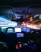 Experience the fast-paced energy of a night drive through Kyoto with vibrant city lights and motion blur.