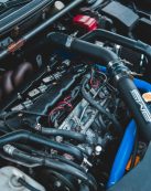 Detailed view of a car engine with visible components, highlighting automotive engineering.